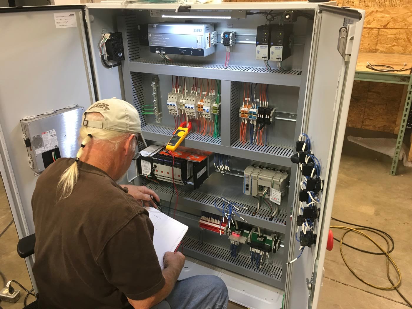 Technician working on an industrial control cabinet