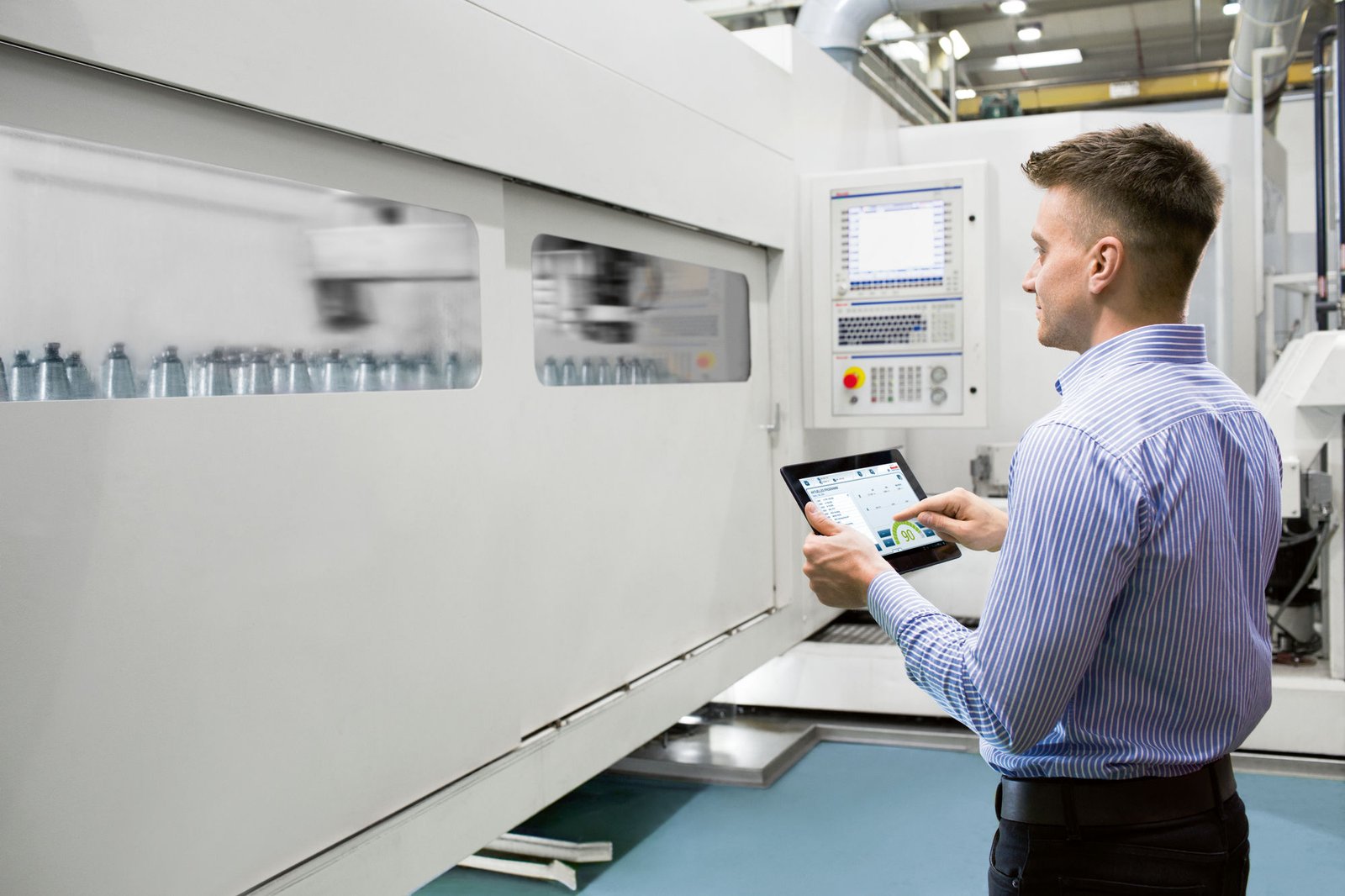 Operator using a tablet to control an industrial automation machine