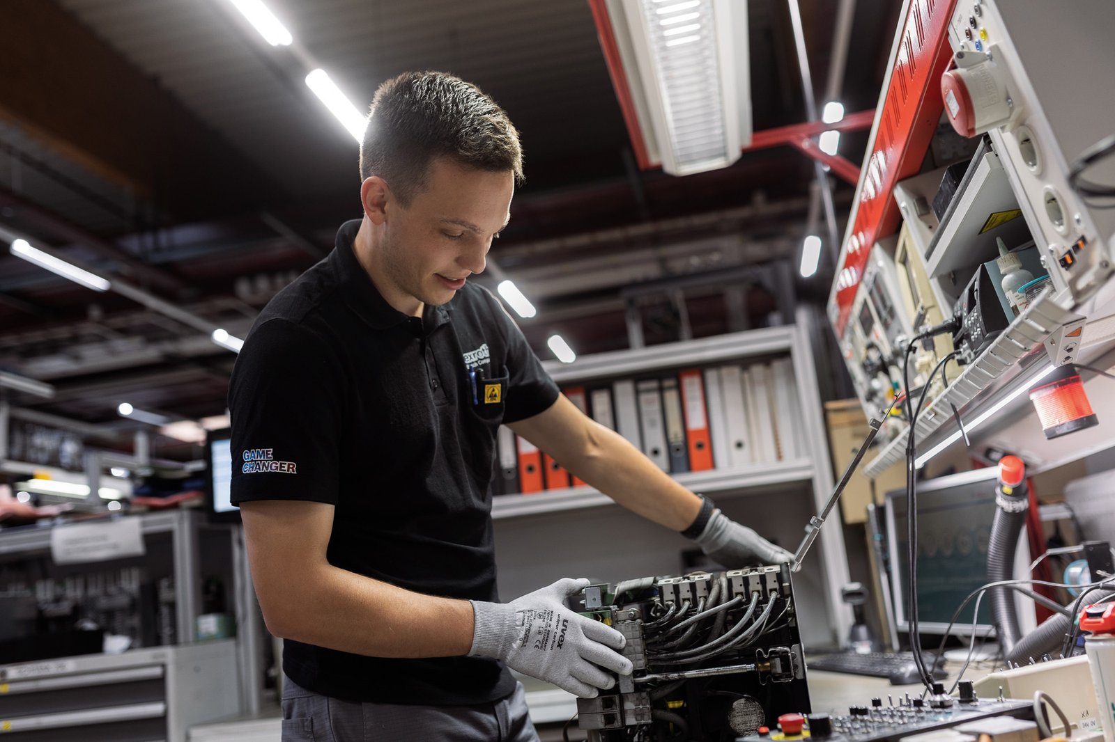 Bosch Rexroth technician repairing industrial electronics in a service workshop